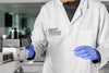 SMART STRAINS scientist placing petri dish under microscope