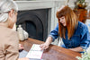 Lady patient pointing at booklet on the table between her and Dr Megan Rossi
