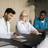 Healthcare professionals in a room reviewing the latest clinical research